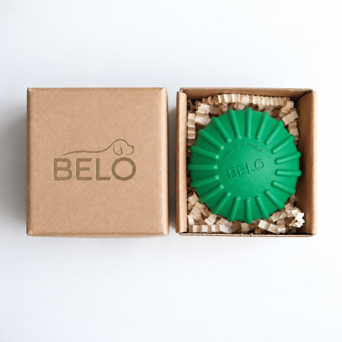 Sprout green BELO Aero Ball dog toy in an open cardboard box beside the branded lid