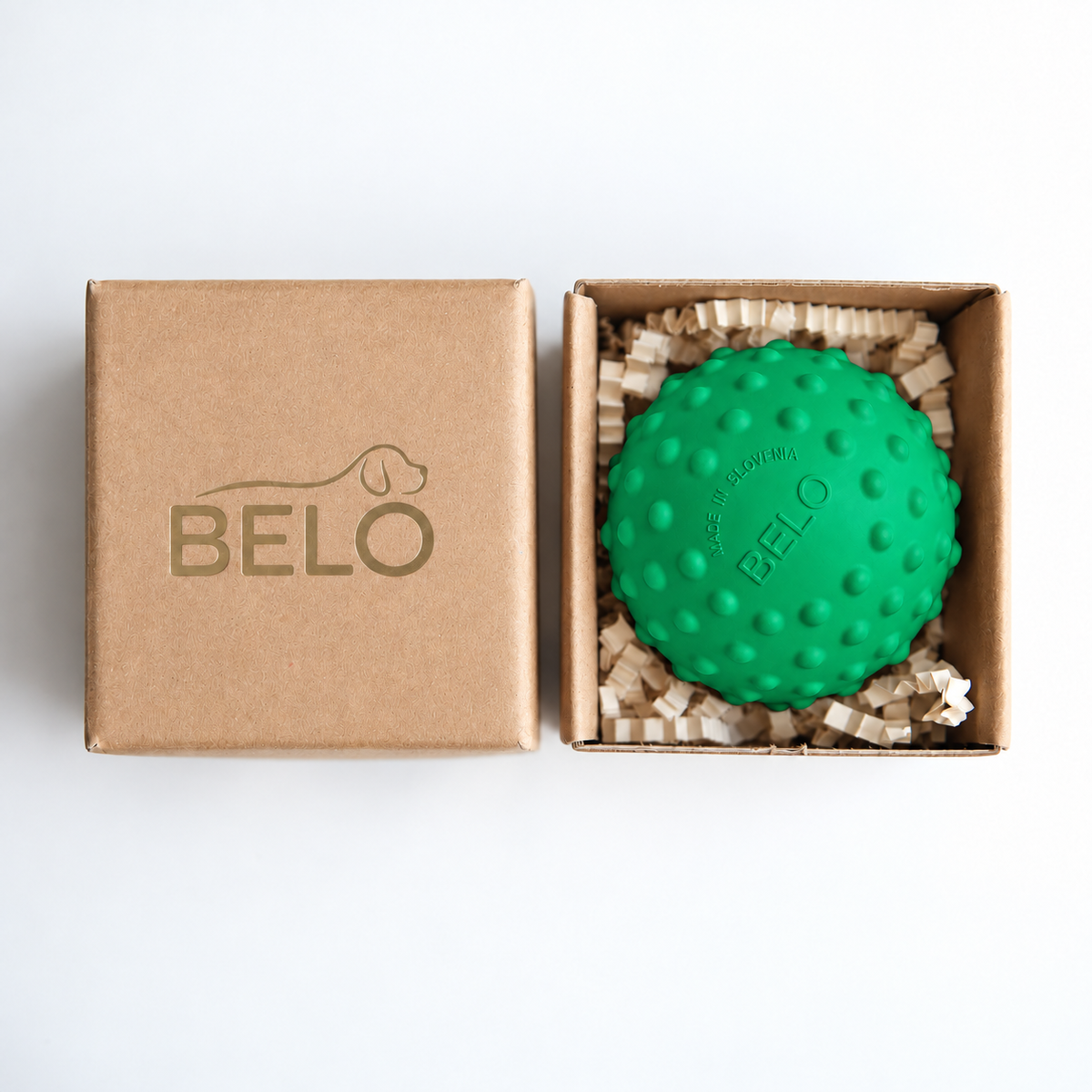 Sprout green BELO Bubble Ball dog toy in an open cardboard box beside the branded lid