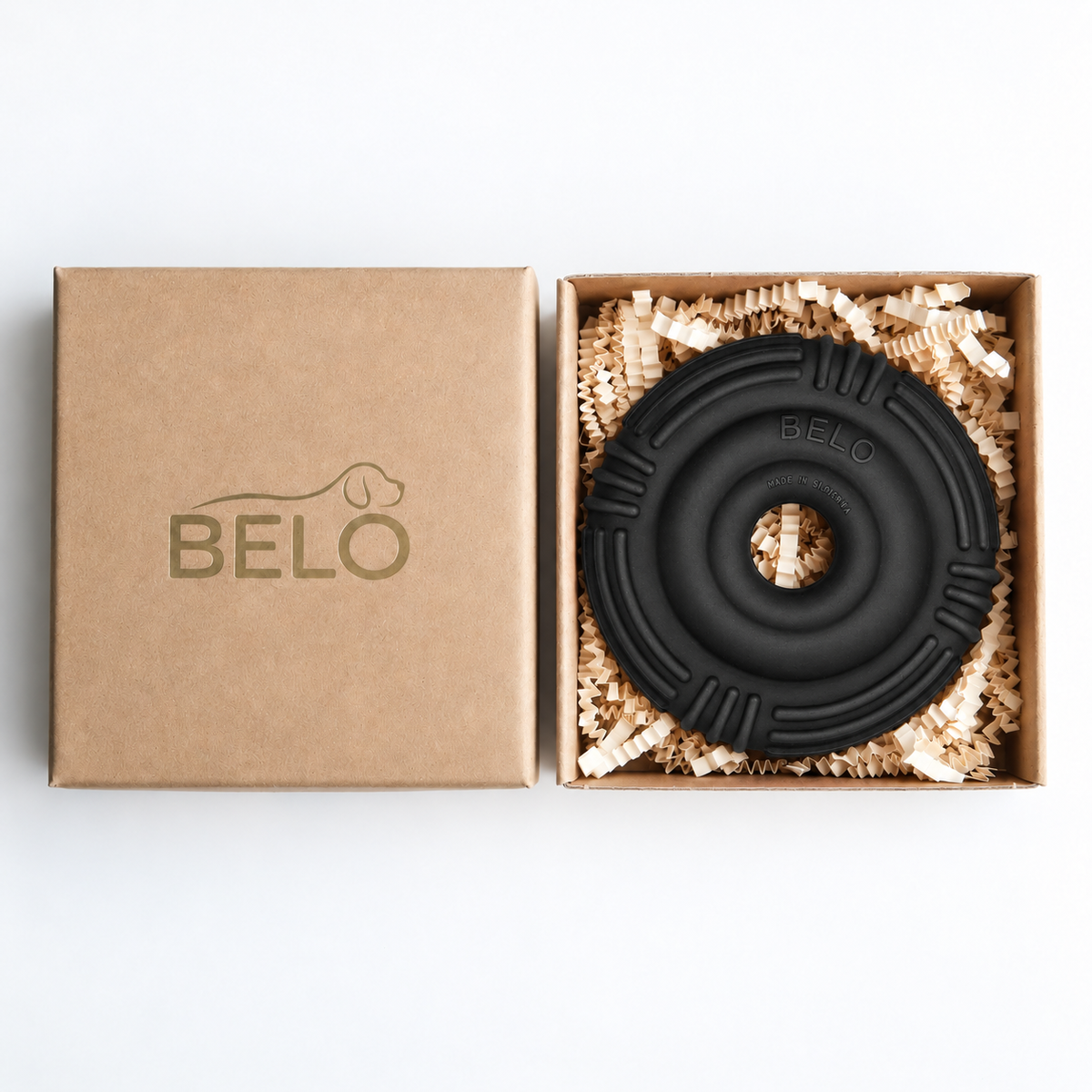 Midnight black BELO Aero Ring dog toy in an open cardboard box beside the branded lid