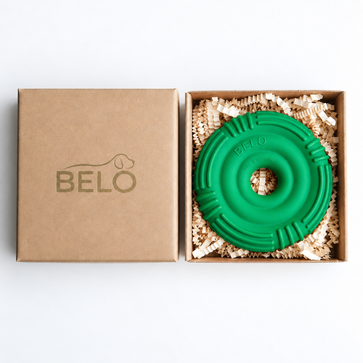 Sprout green BELO Aero Ring dog toy in an open cardboard box beside the branded lid