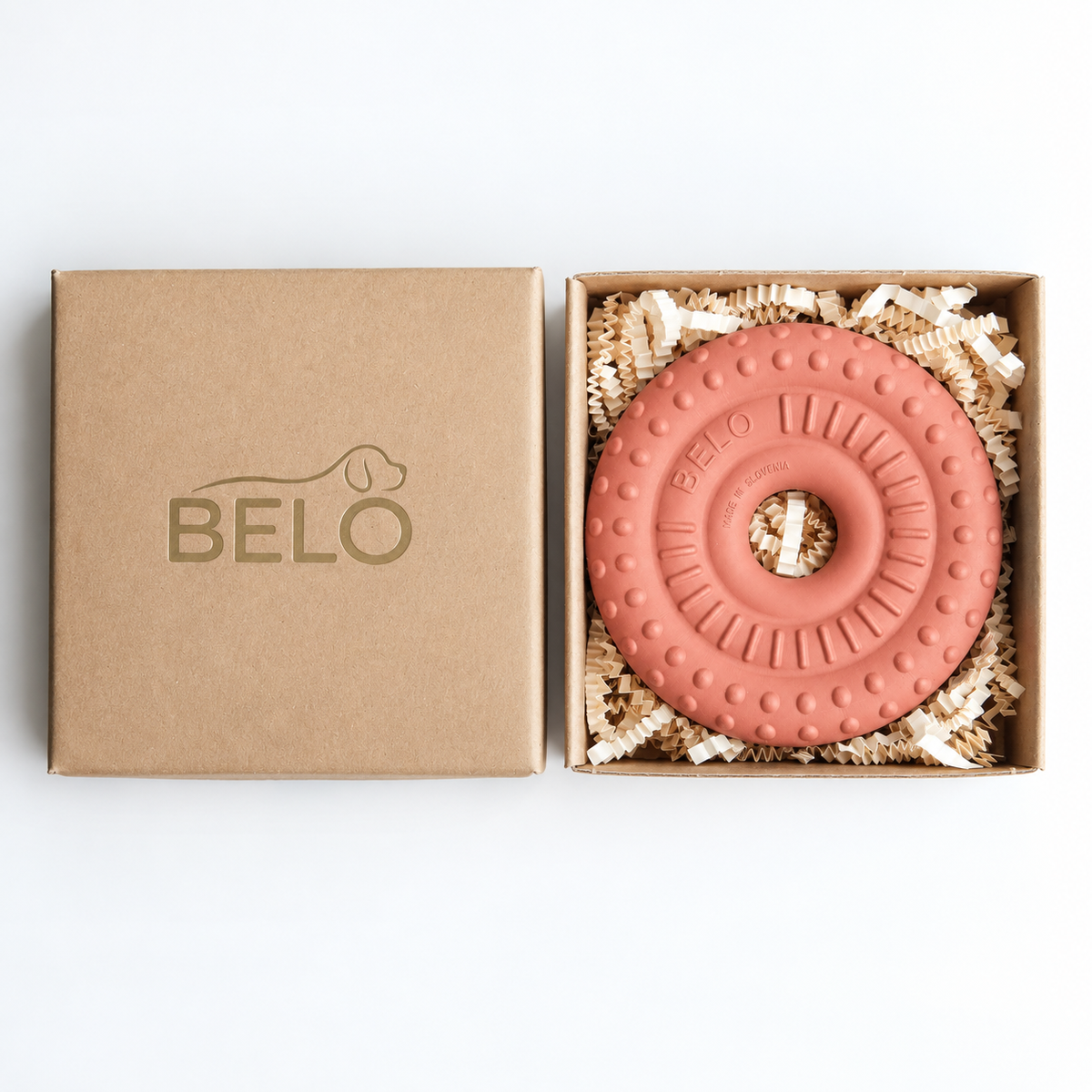 Berry pink BELO Bubble Ring dog toy in an open cardboard box beside the branded lid