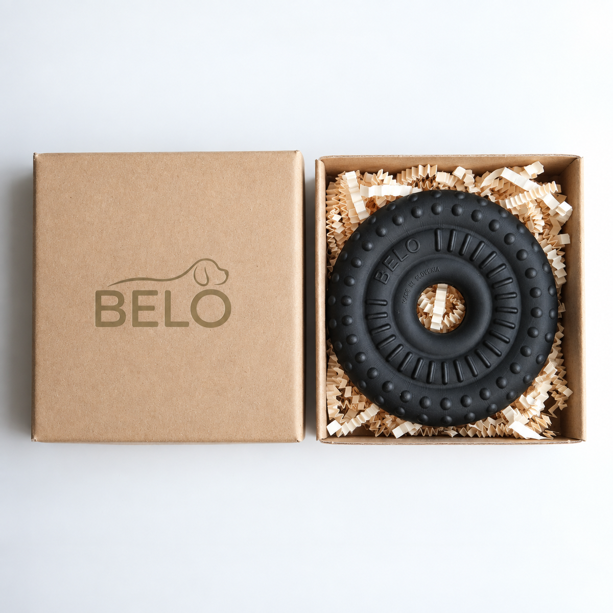 Midnight black BELO Bubble Ring dog toy in an open cardboard box beside the branded lid