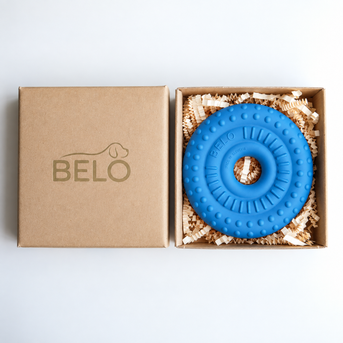 Sky blue BELO Bubble Ring dog toy in an open cardboard box beside the branded lid